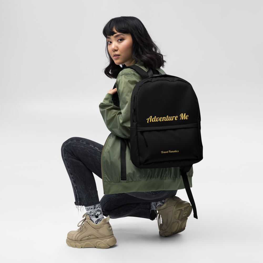 Person wearing a black backpack with 'Adventure Me' text on a white background