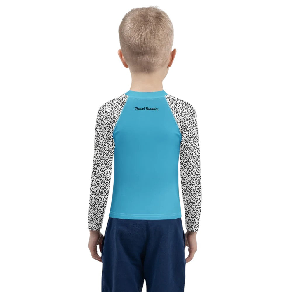 Child wearing a blue and patterned long-sleeve shirt on a white background