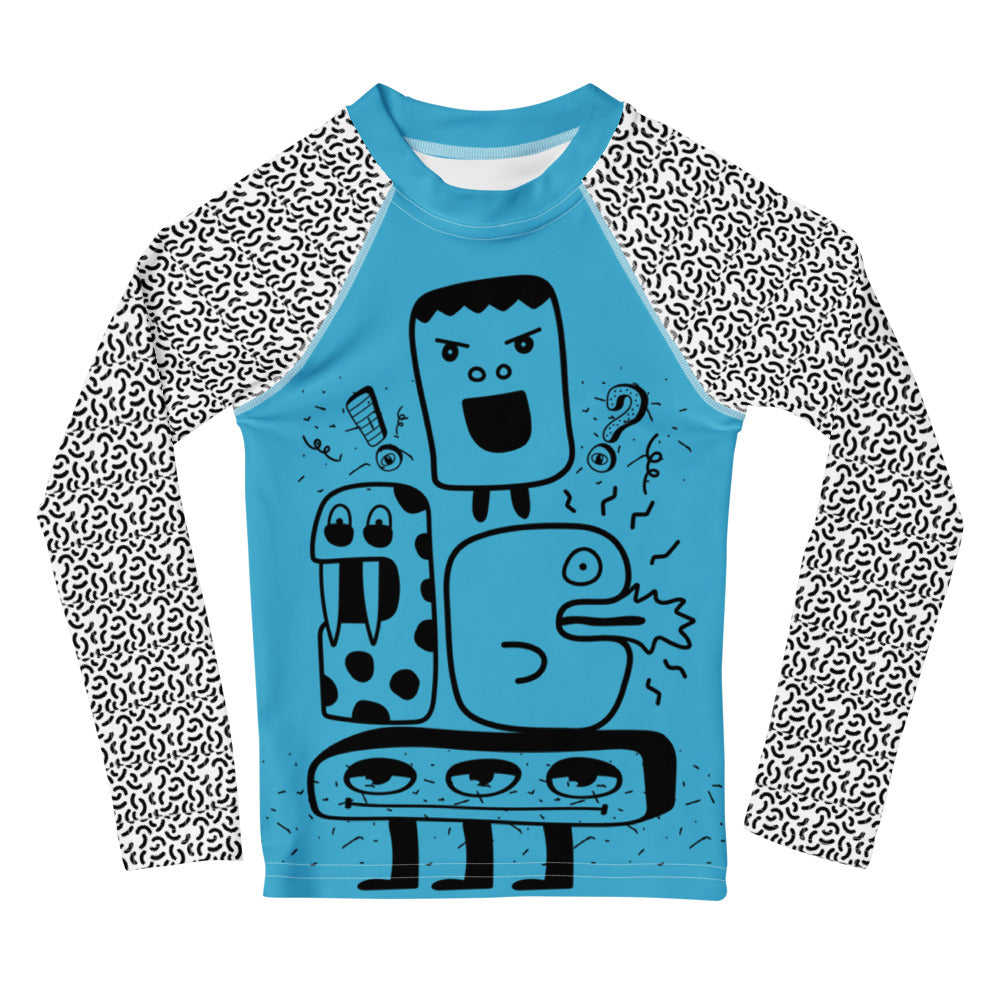 Blue long-sleeve shirt with black and white patterned sleeves featuring cartoonish monster design on a white background.