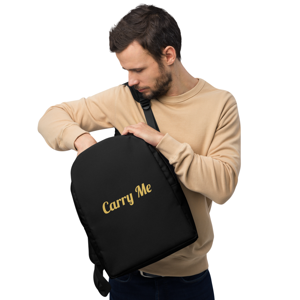 Man holding a black bag with 'Carry Me' text on a white background