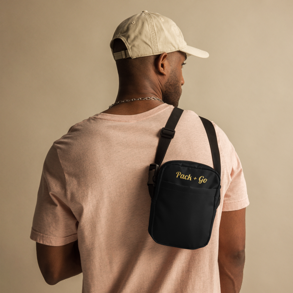 Man wearing a beige cap and light pink shirt with a black 'Pack & Go' bag on a beige background