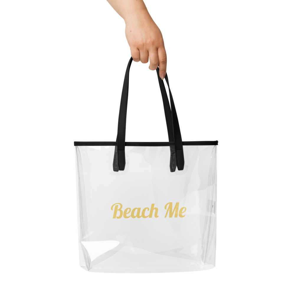 Clear tote bag with black handles and 'Beach Me' text on a white background