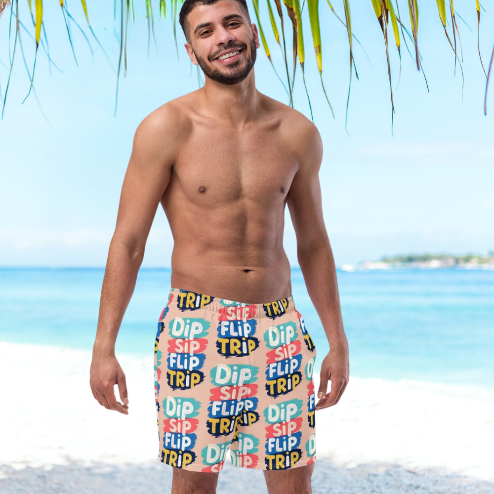 Man wearing colorful swim shorts with beach background