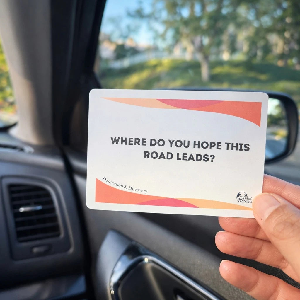Hand holding a card with text 'Where do you hope this road leads?' inside a car.