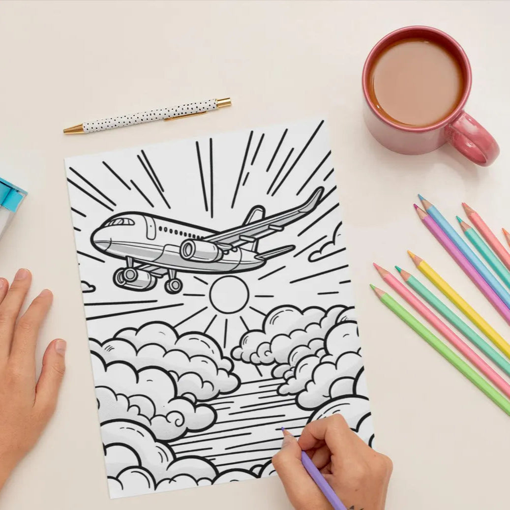Coloring book with airplane design, coloring pencils, and a mug on a table.