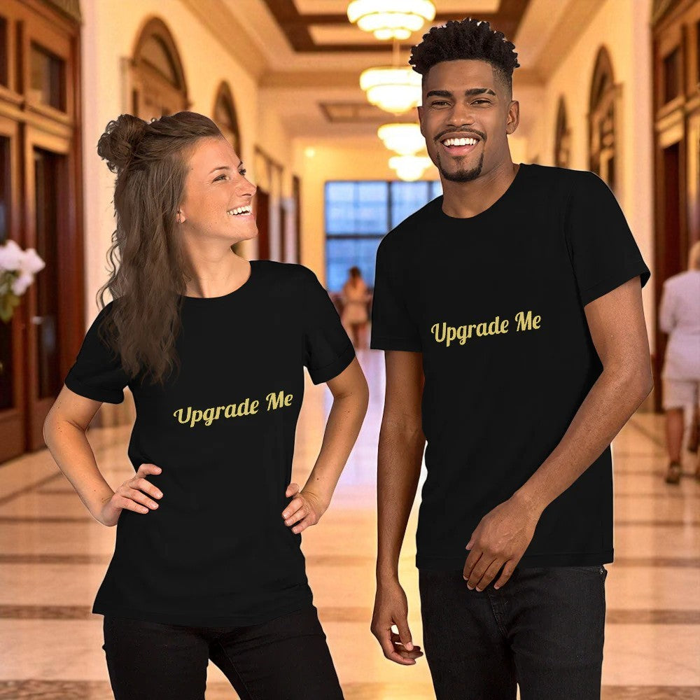 Two people wearing black t-shirts with 'Upgrade Me' text in a hallway.