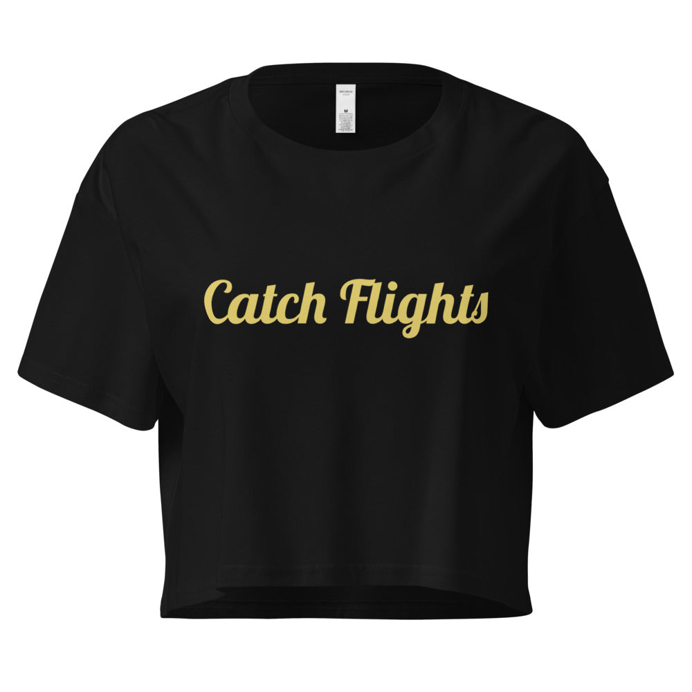Black crop top with 'Catch Flights' text in gold on a white background