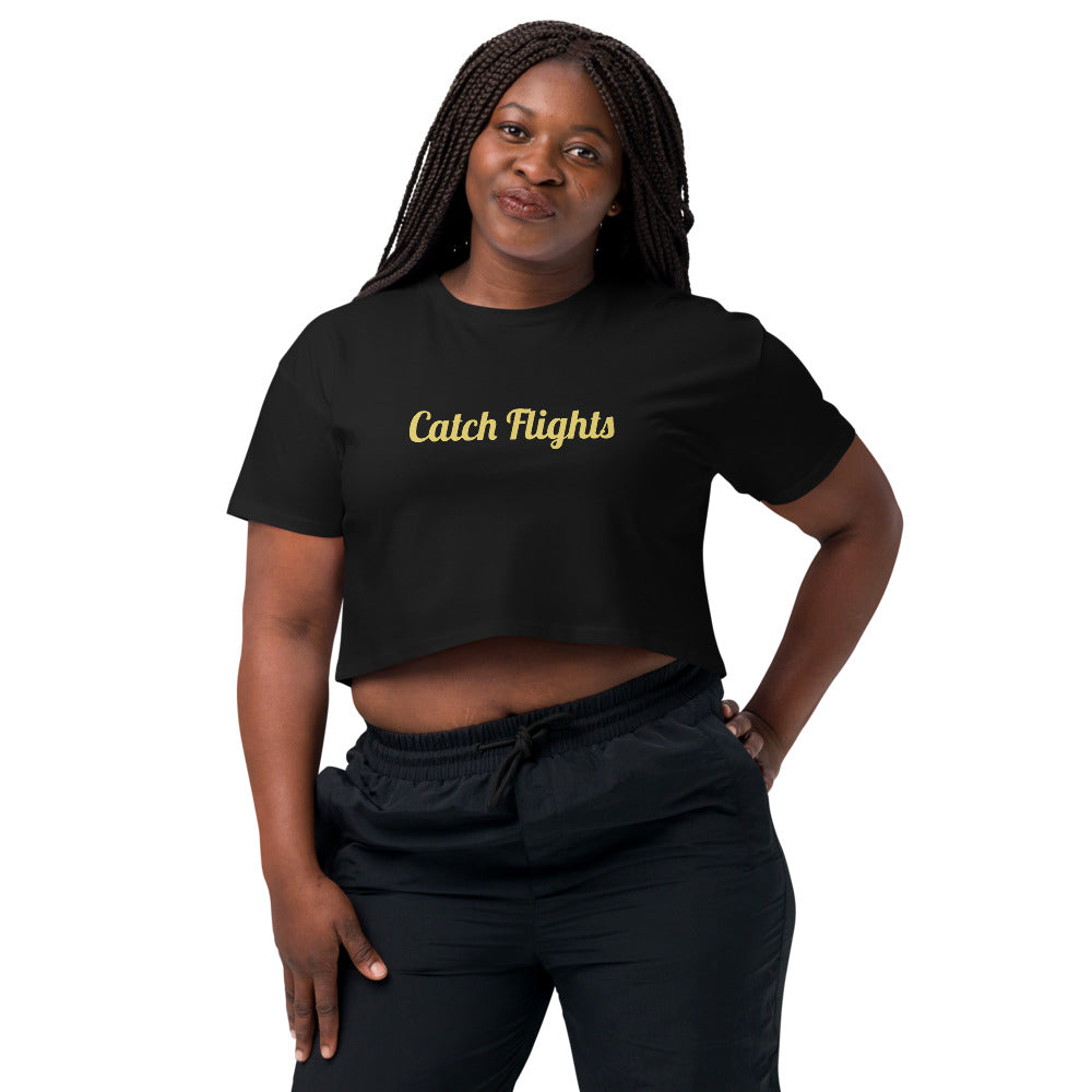 Person wearing a black crop top with 'Catch Flights' text on a white background