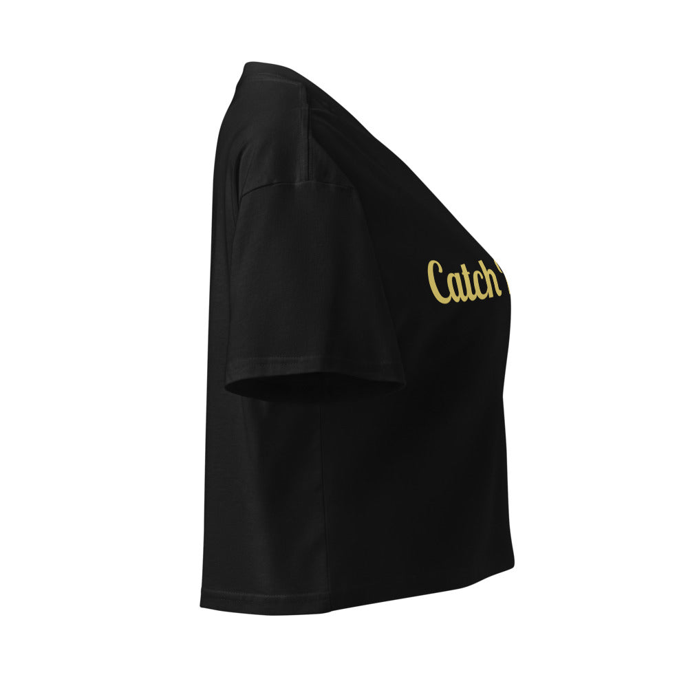Black crop top with 'Catch' text in gold on a white background