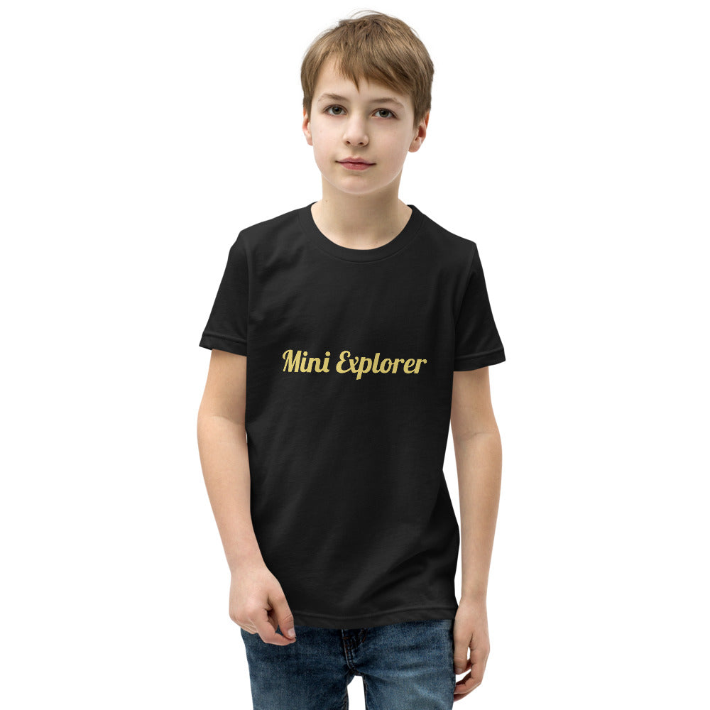 Child wearing a black t-shirt with 'Mini Explorer' text on a white background