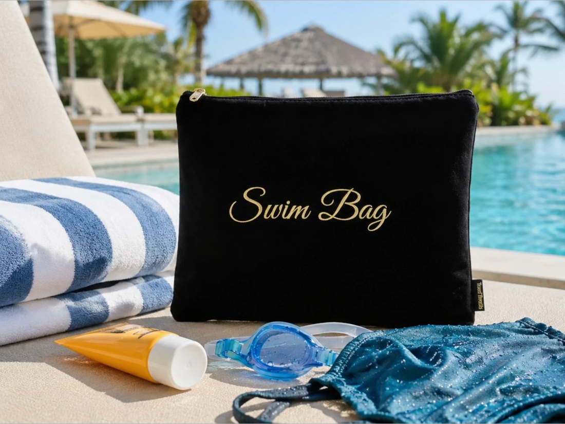 Wet bag for swimsuits with towel, sunscreen, goggles, and damp swimsuit by a hotel pool
