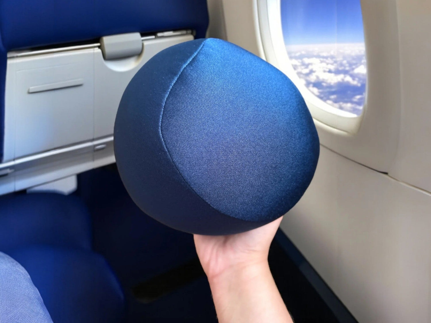 airplane window with ball pillow