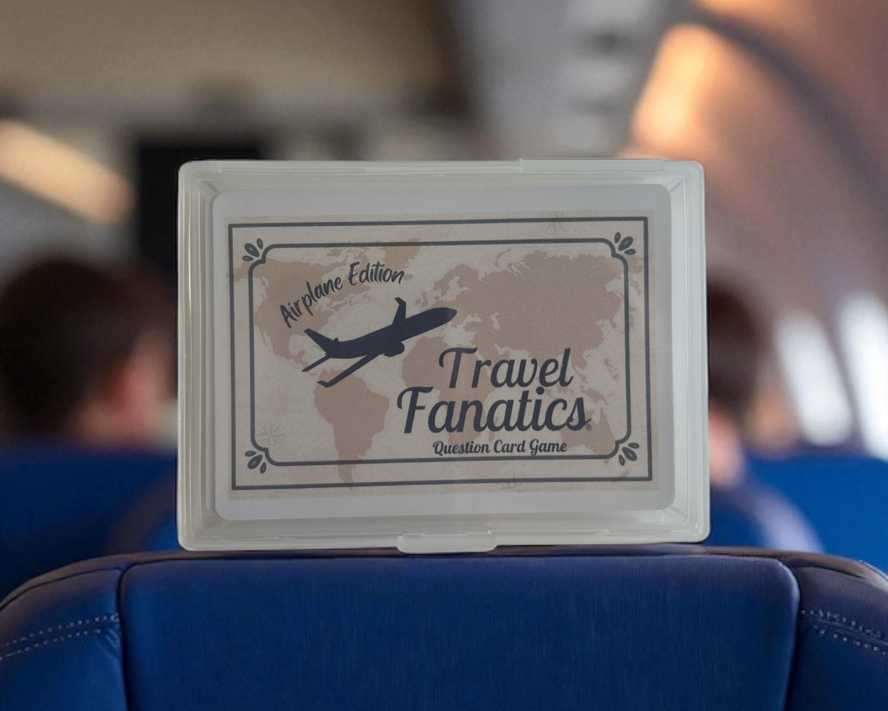 Travel Fanatics card game box on an airplane seat


