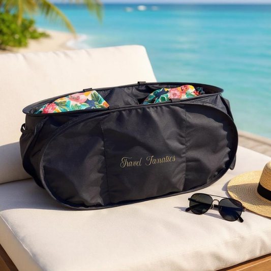 Black travel bag with floral accents on a sun lounger by the beach

