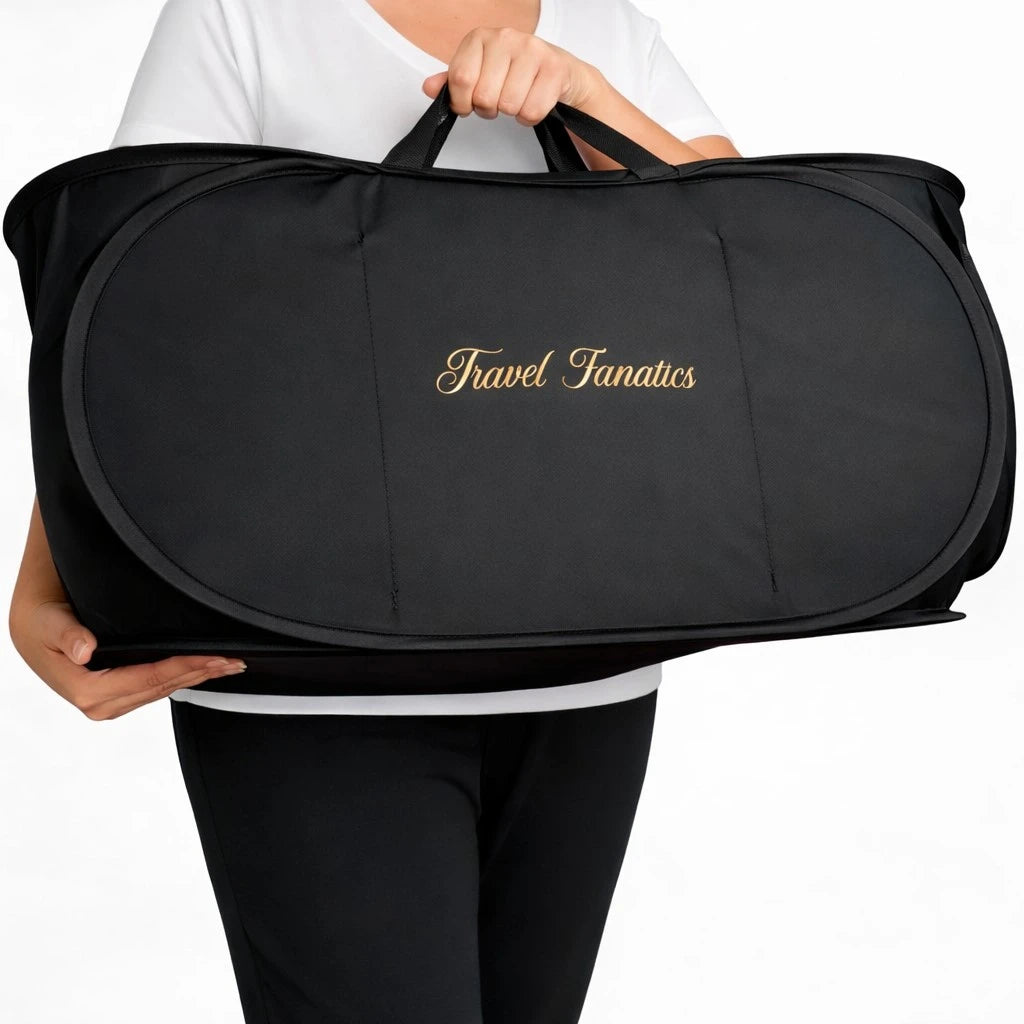 Black duffel bag with 'Travel Fanatics' branding held by a person on a white background

