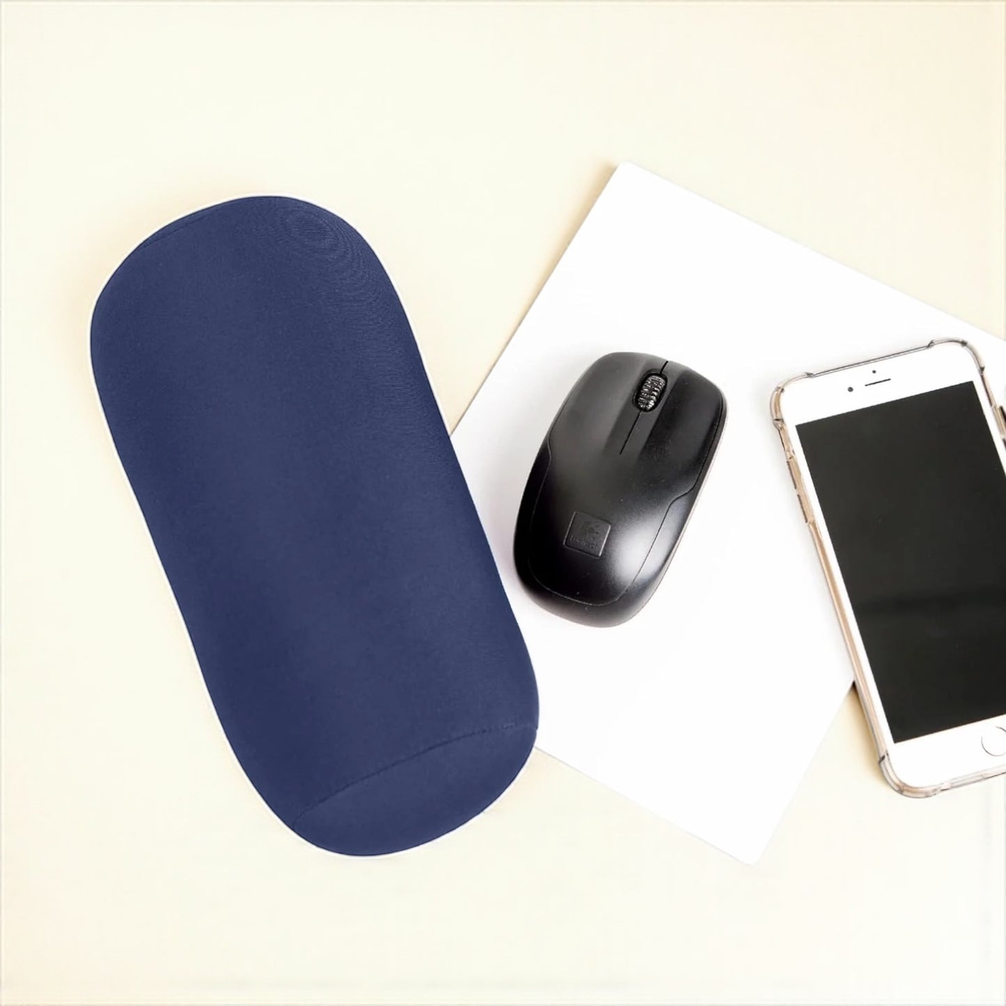 Blue wrist rest, black mouse, and smartphone on a light surface

