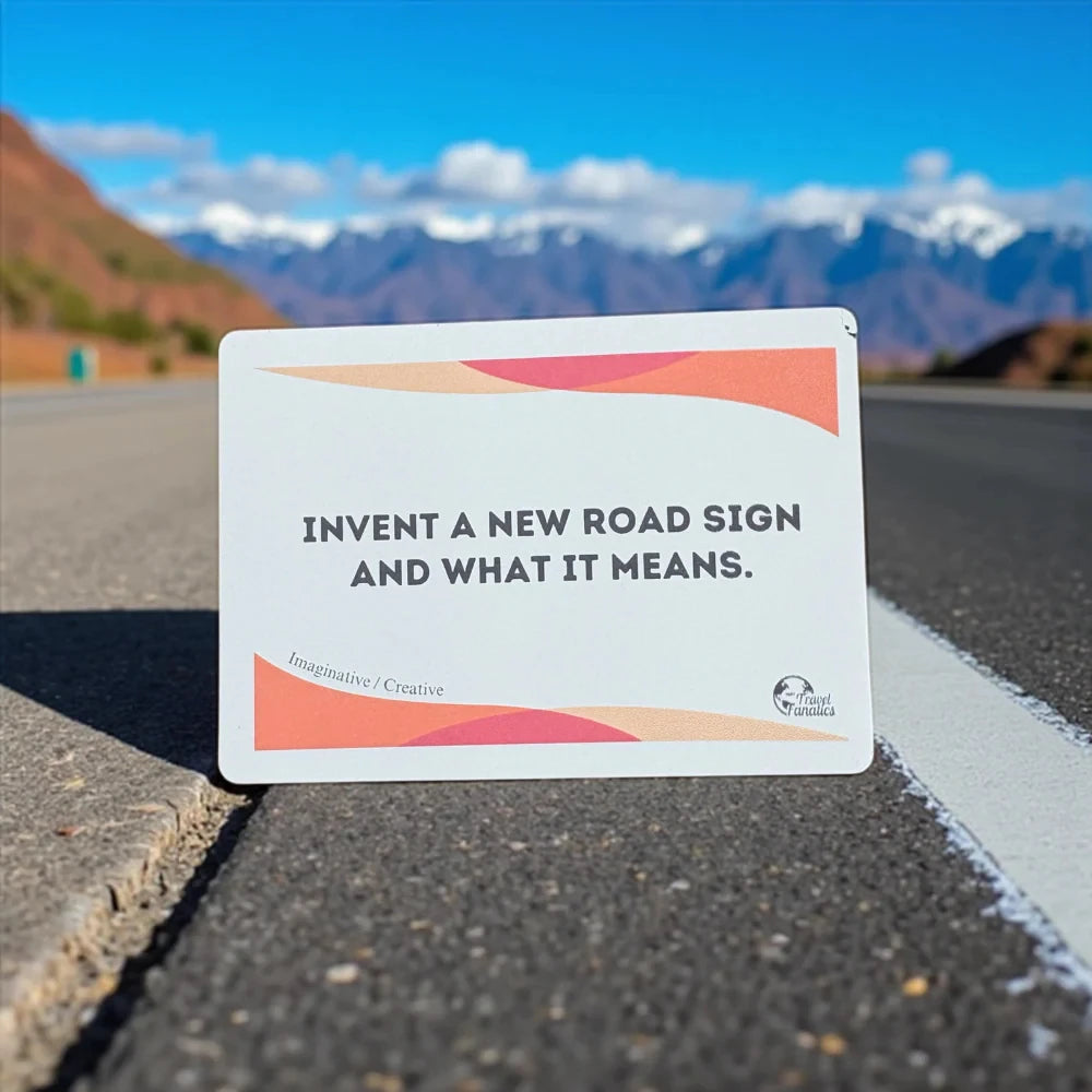 Road sign with text 'Invent a new road sign and what it means.' on a mountainous background

