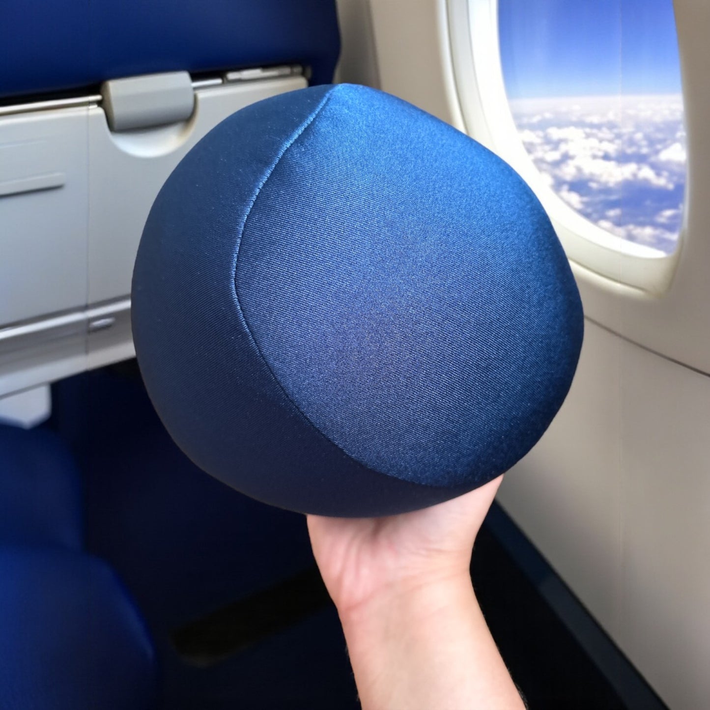 Bolster pillow used while traveling on a plane, supporting head and shoulders.
