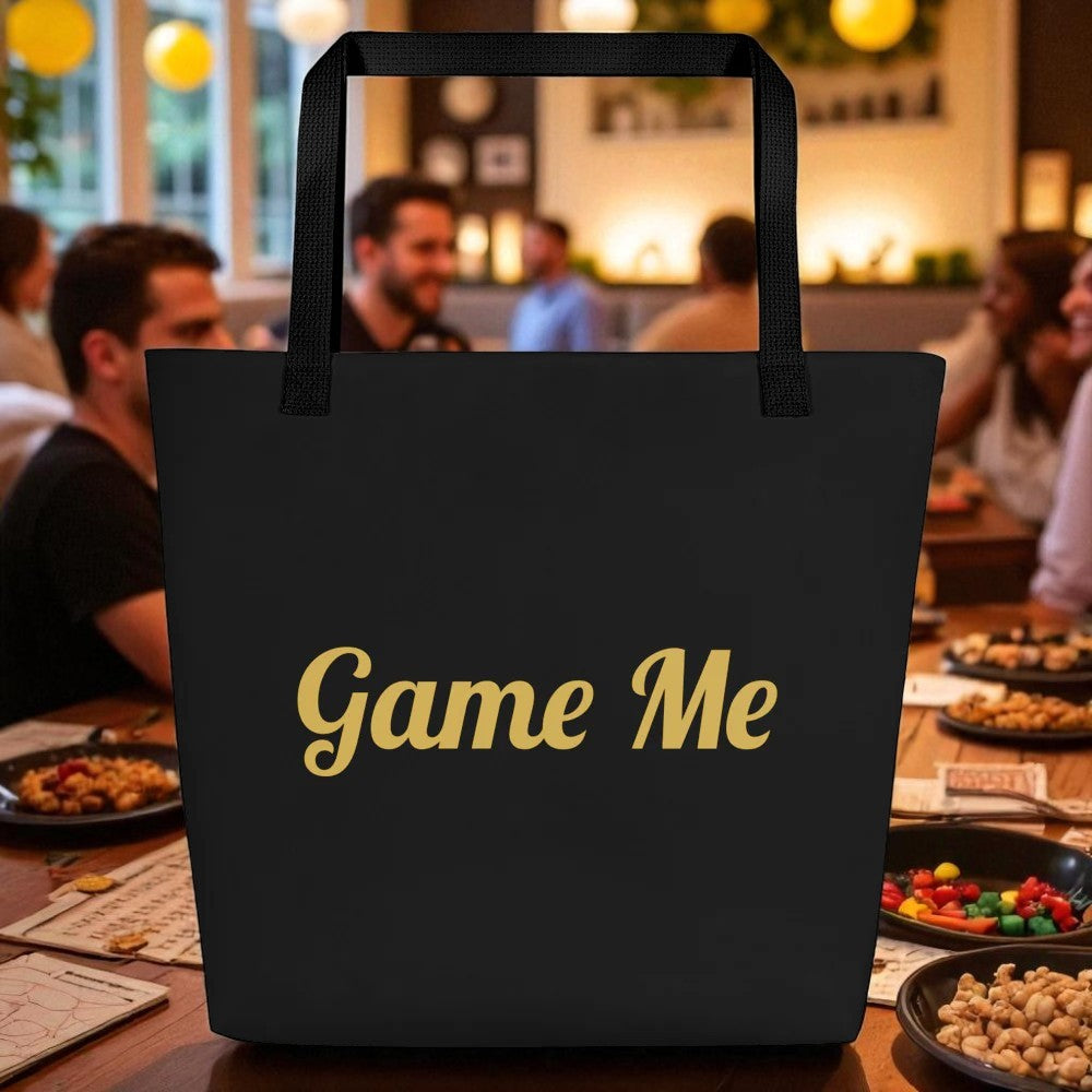 Black tote bag with 'Game Me' text on a table in a restaurant setting

