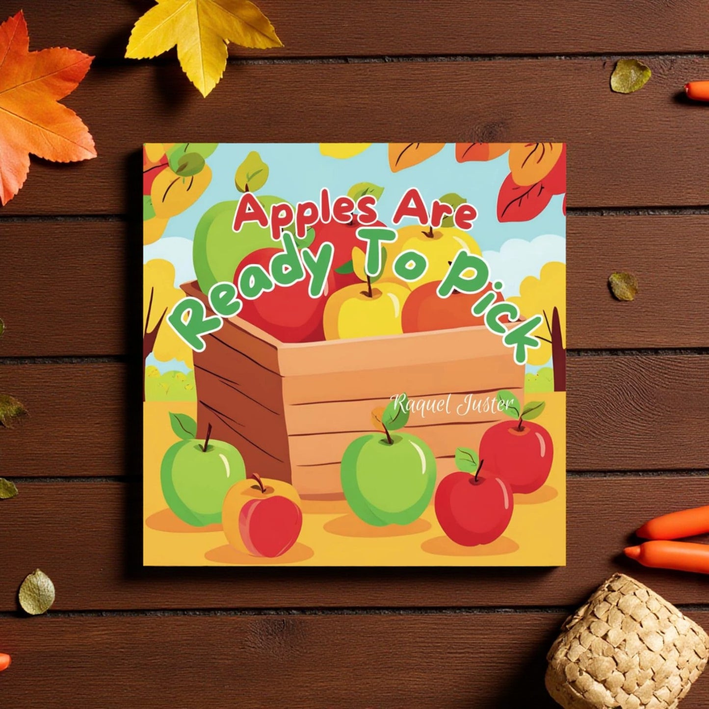 Children's book cover with apples and a wooden crate on a wooden surface.

