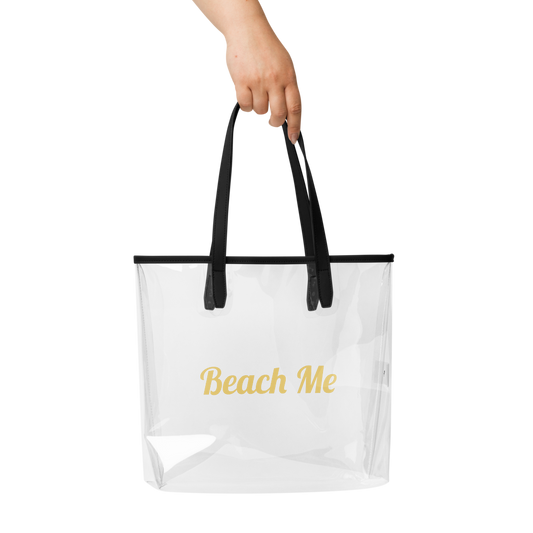 Clear tote bag with black handles and 'Beach Me' text on a white background

