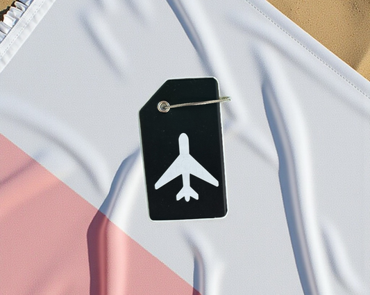Luggage tag with airplane icon on a fabric background

