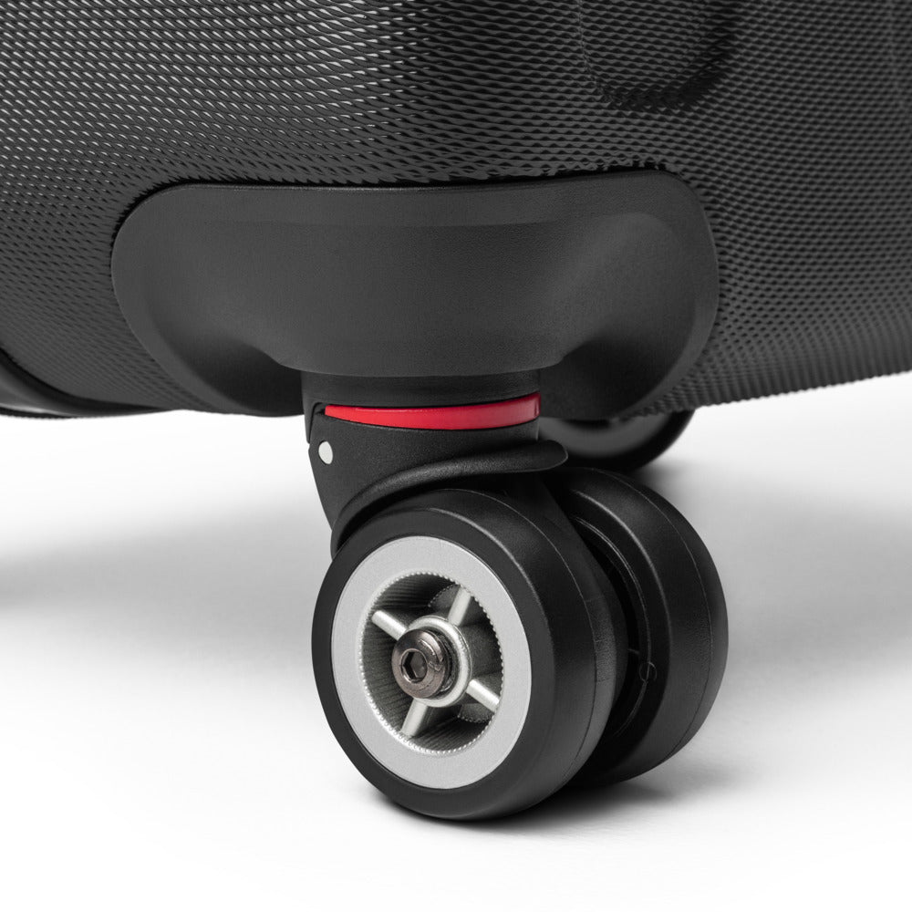 Close-up of a suitcase wheel on a white background