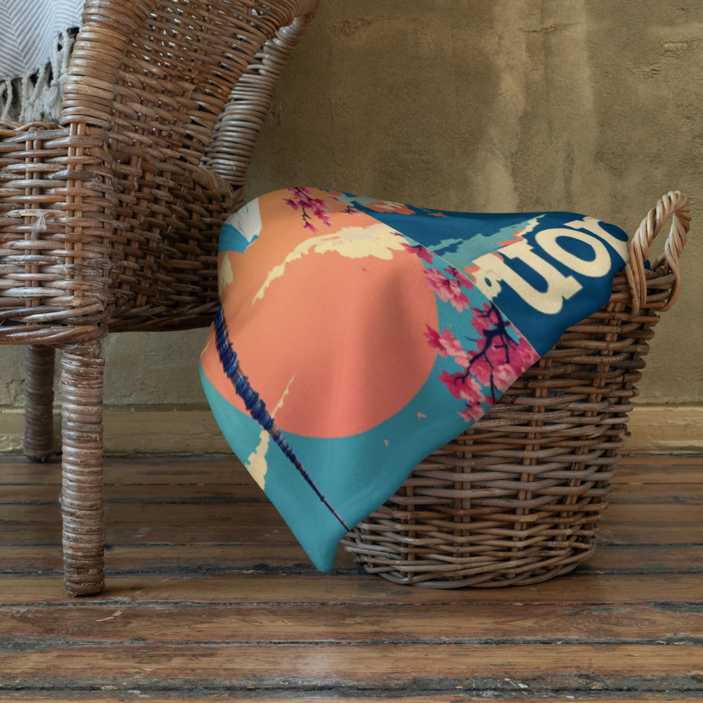 Colorful patterned blanket draped over a wicker chair against a wooden floor and wall.

