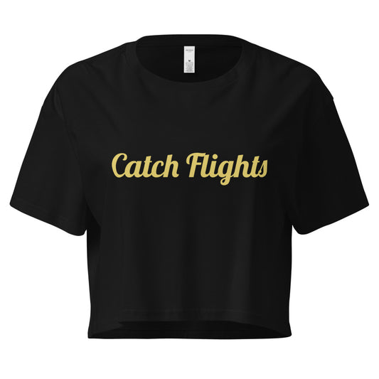 Black crop top with 'Catch Flights' text in gold on a white background

